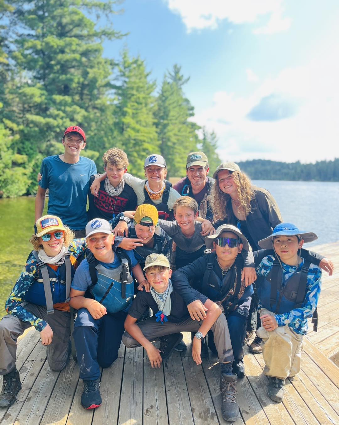 Group of friends outdoors by a lake.