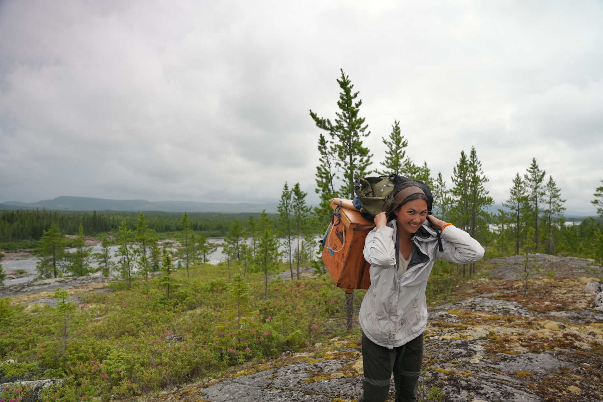 Hiker carrying backpack in forested landscape