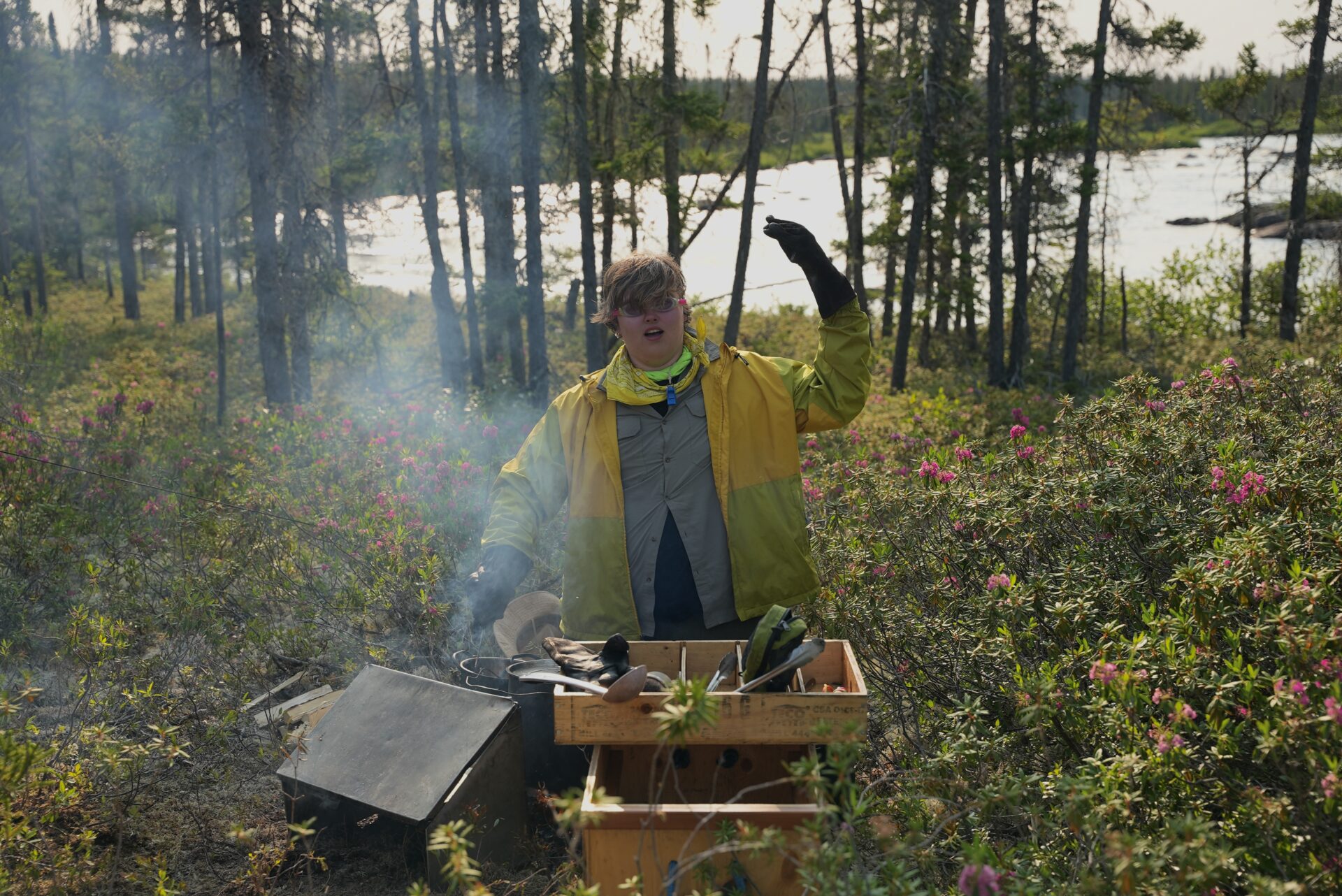 Person in forest bee-keeping near river