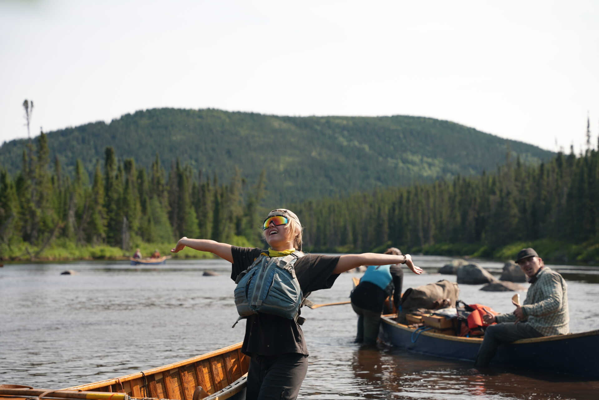 People enjoying canoe trip in scenic mountain river