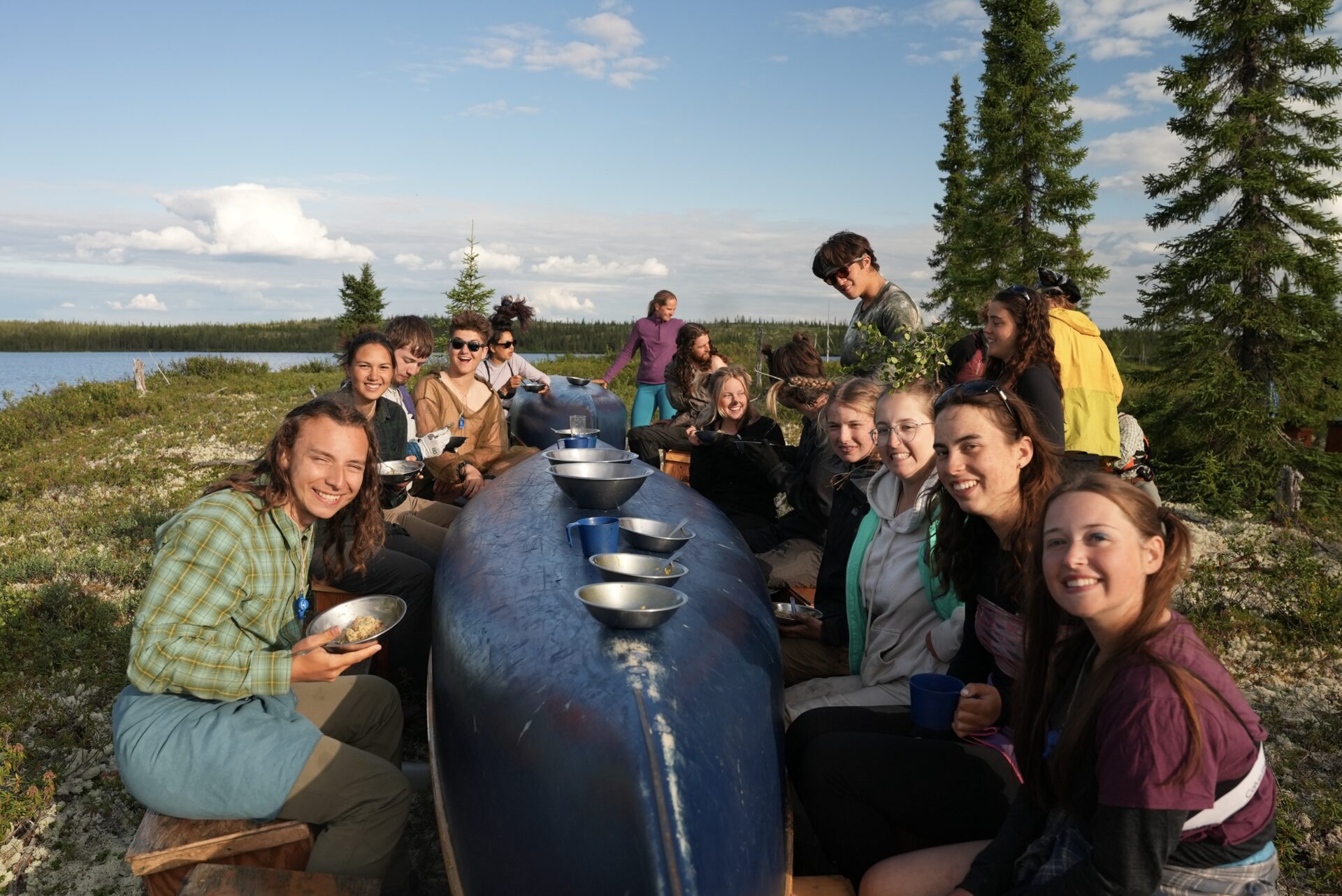 Group enjoying meal at outdoor table.