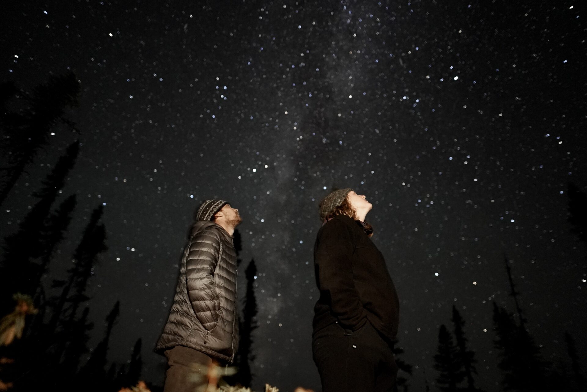 Two people stargazing at night.