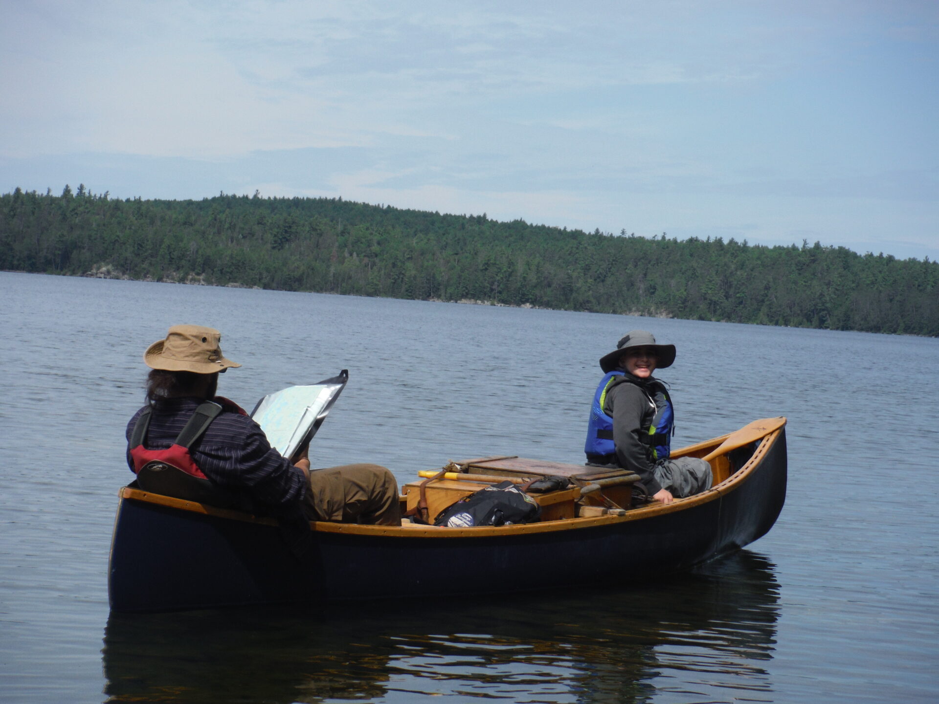 Two people canoeing on a lake.