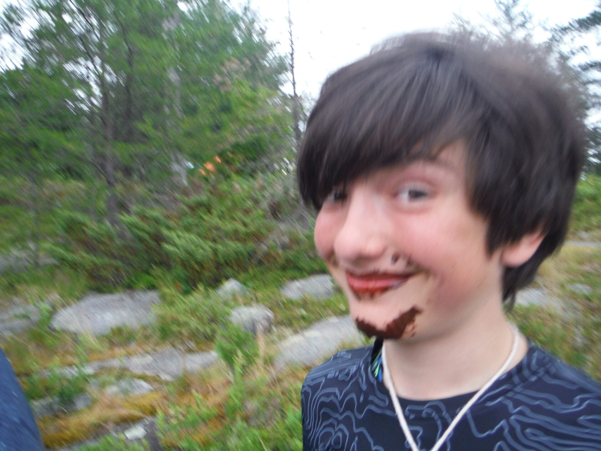 Child with chocolate-covered face outdoors