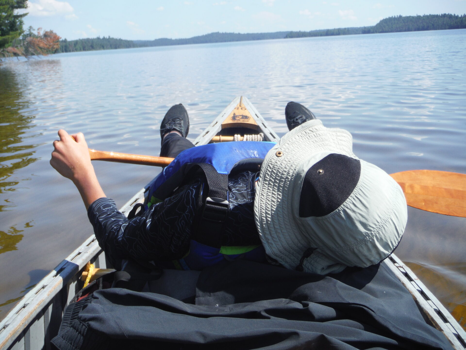 Person canoeing on calm lake