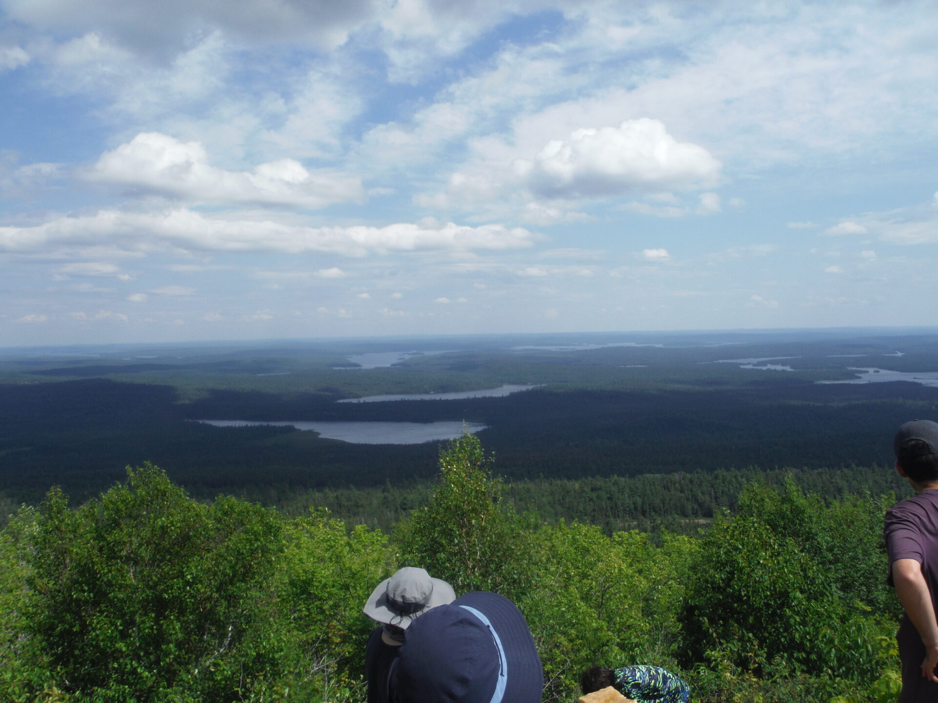 People enjoying a scenic forest and lake view