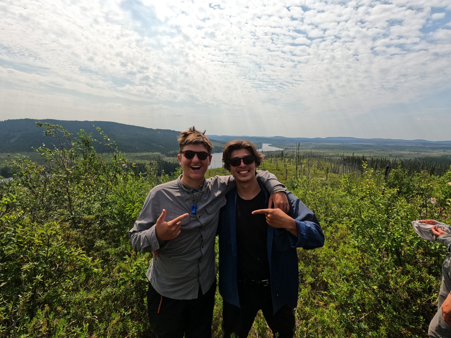 Two friends in nature with scenic background.