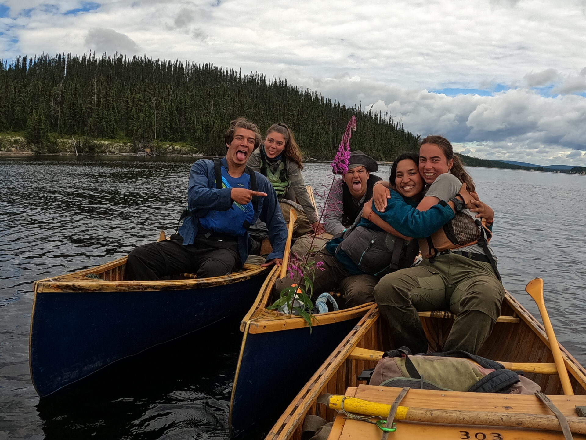 Happy friends in canoes on a lake