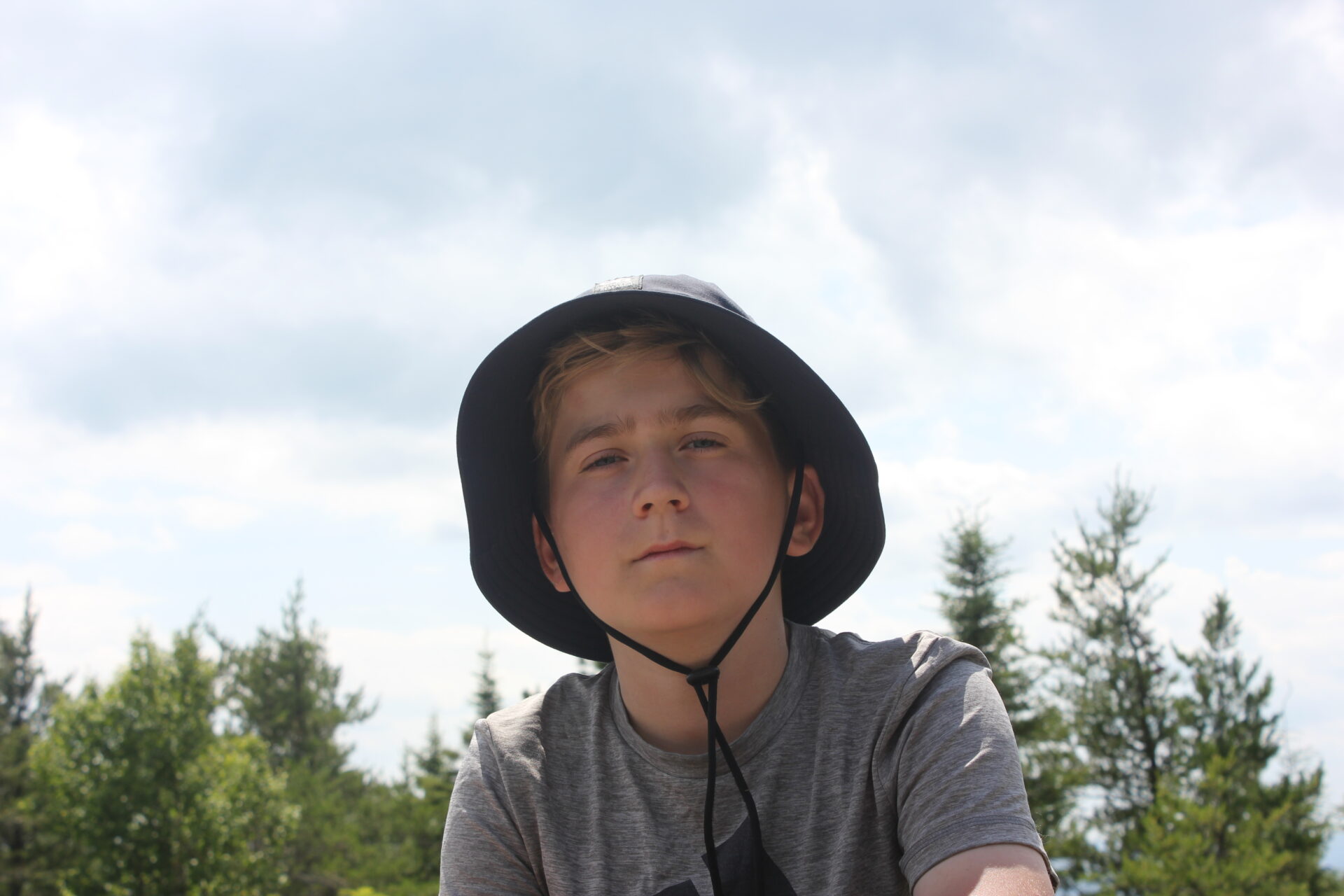 Young person outdoors wearing bucket hat