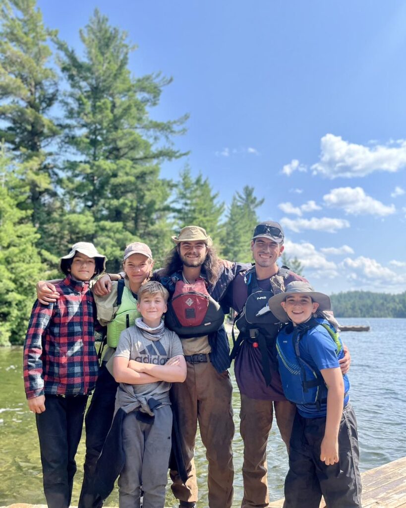 Group of friends at lakeside outdoors.