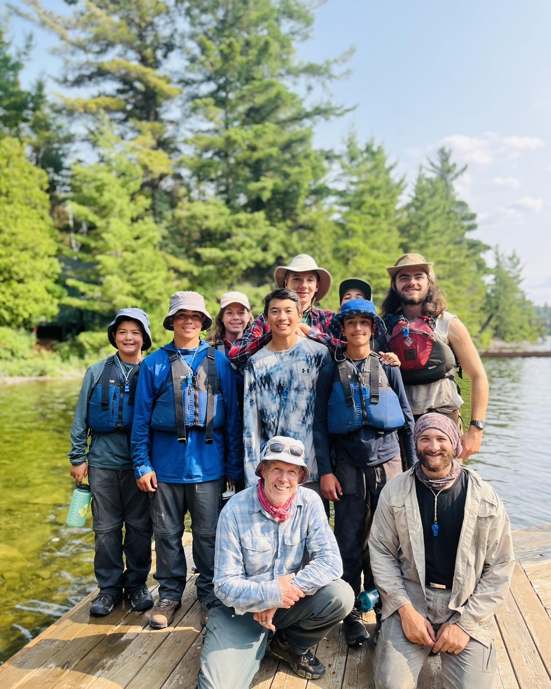 Group photo outdoors on a dock.