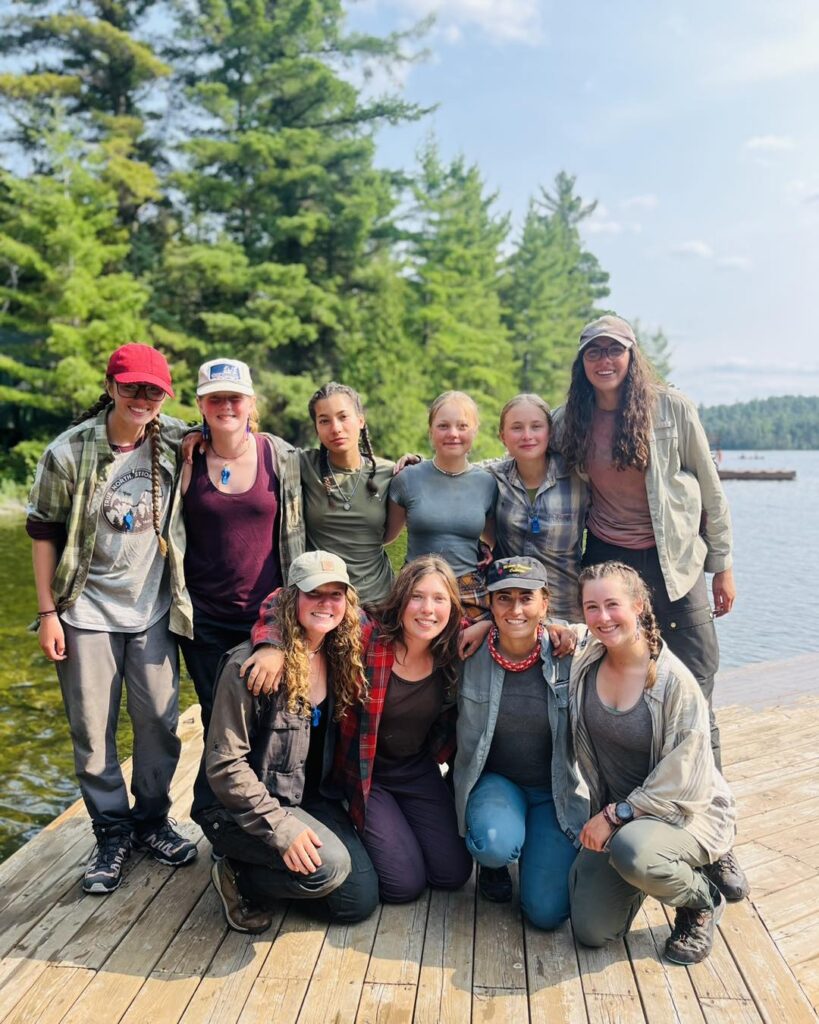 Group of people on wooden dock by lake