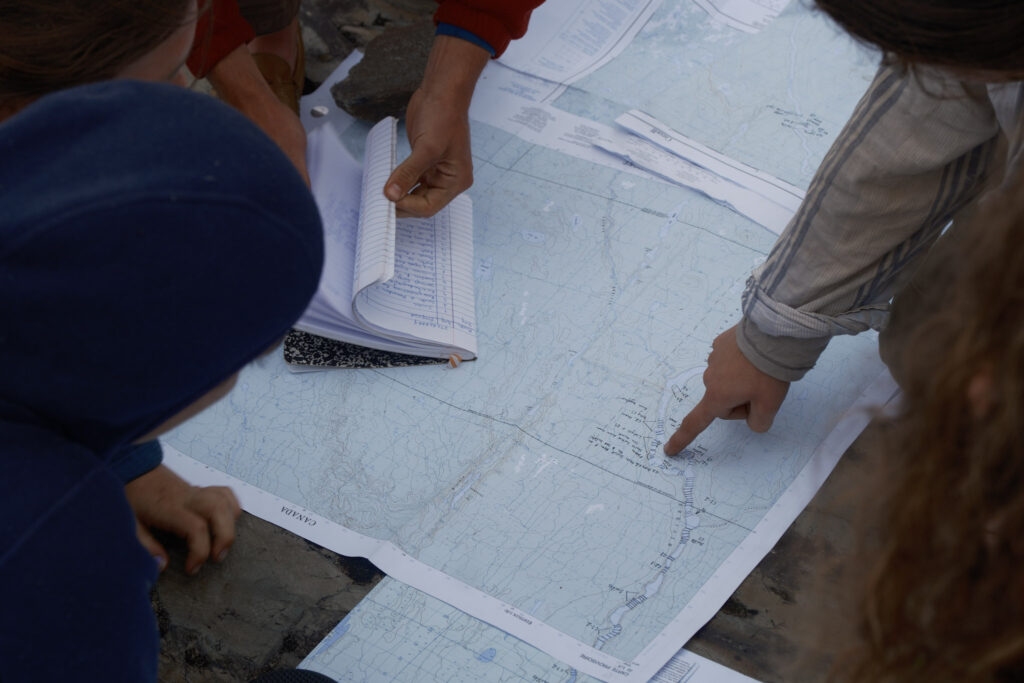 Group studying a map outdoors.