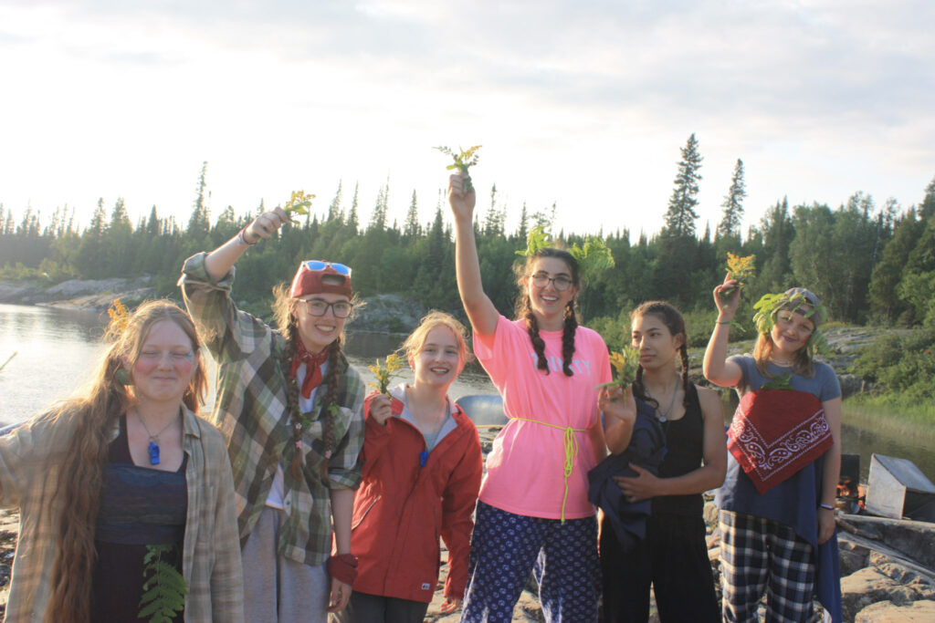 Group of friends outdoors by a river.